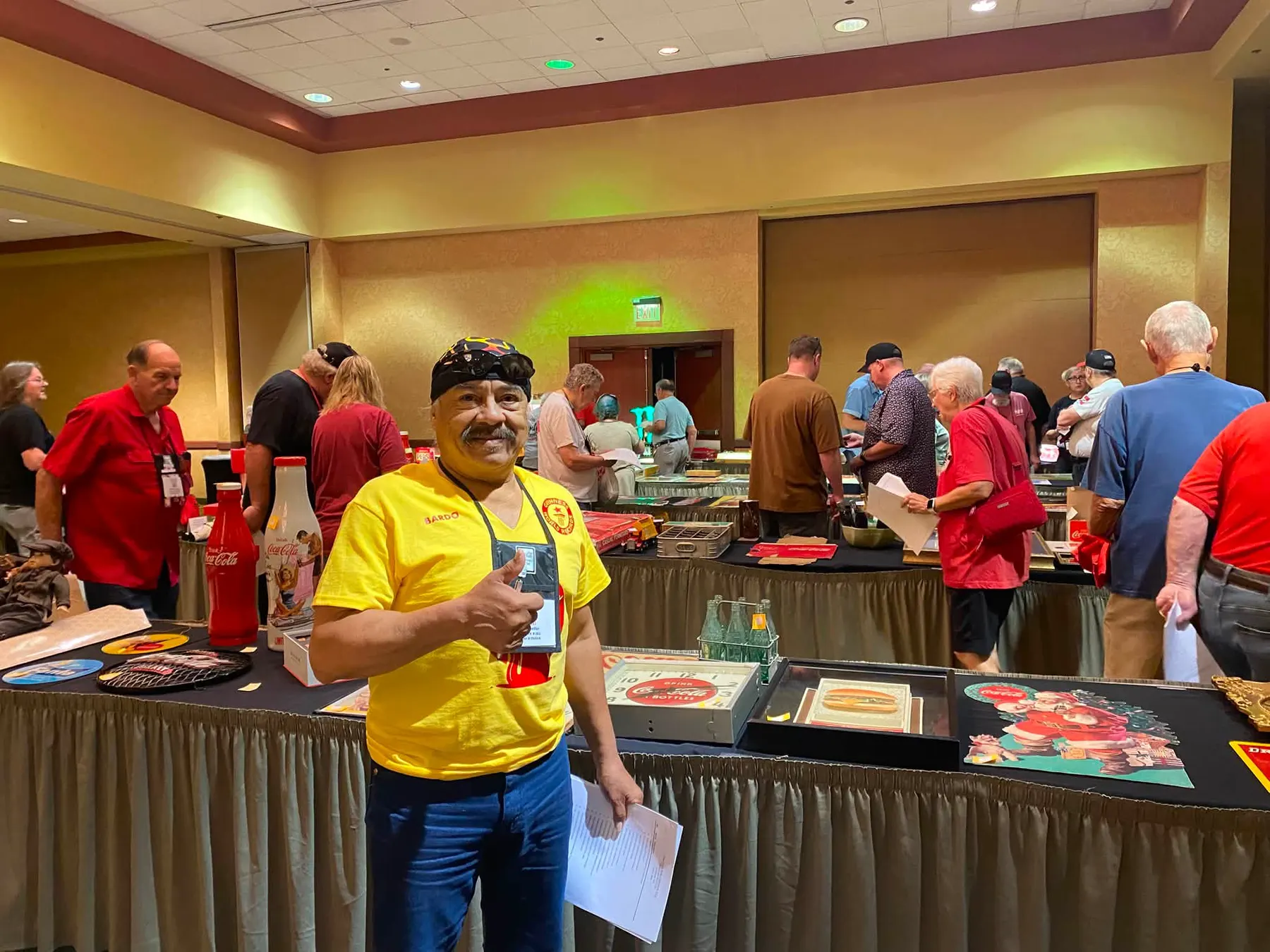 Bardo Cuellar giving a thumbs up in the auction room at the Coca-Cola Collectors Club convention