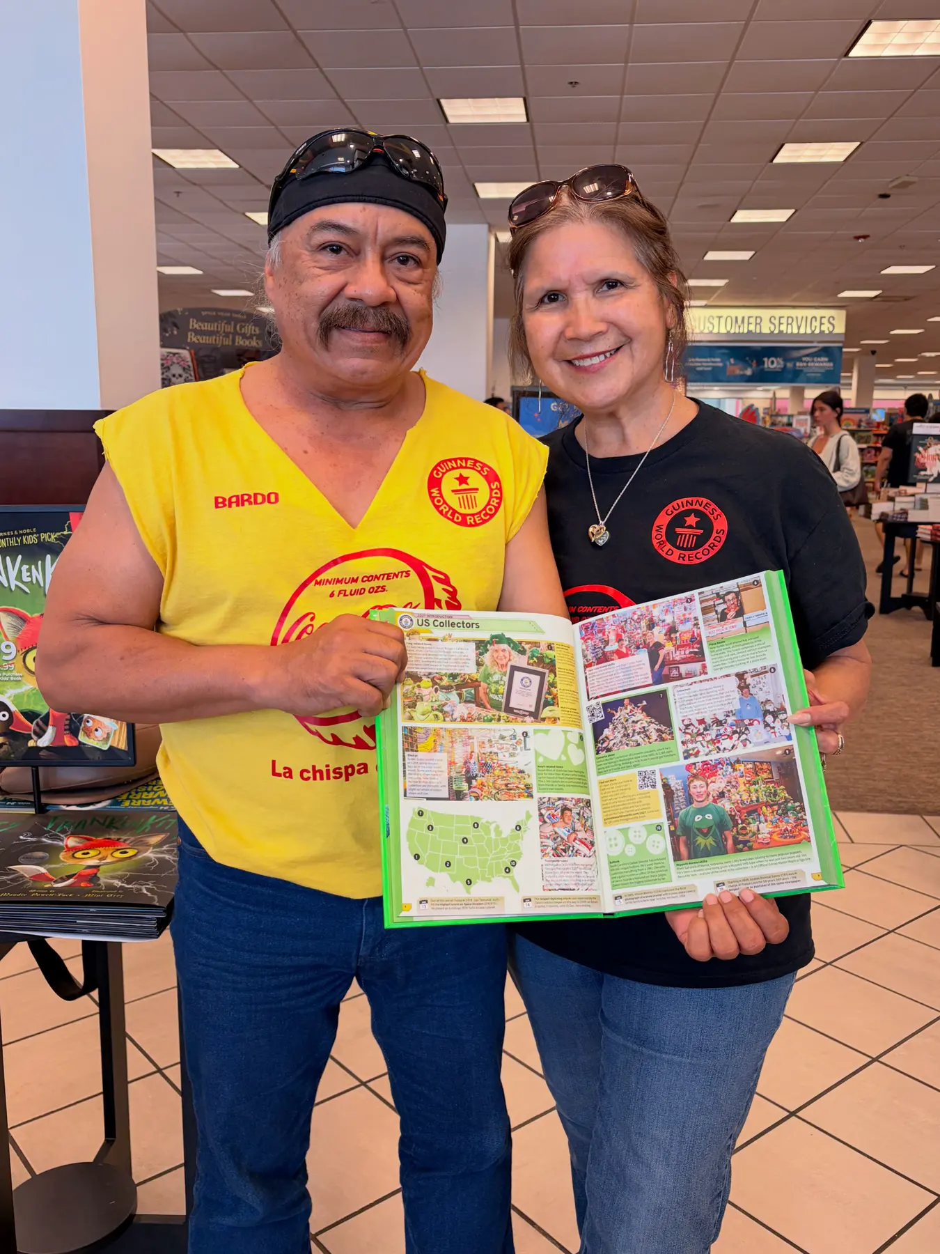 Bardo and Olga Cuellar holding Guinness World Records 2027 open to their Coca-Cola memorabilia entry