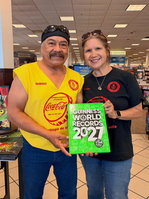 Bardo and Olga Cuellar holding Guinness World Records 2027 at Barnes & Noble Deerbrook