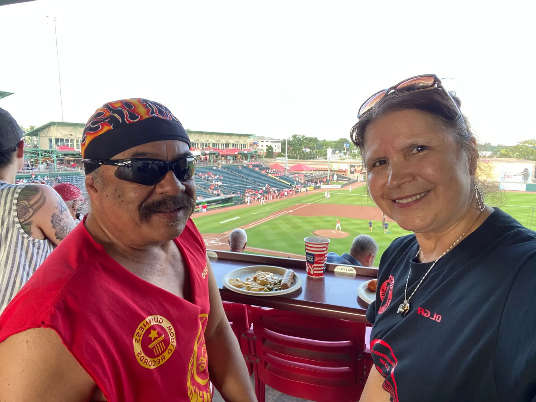 Bardo and Olga Cuellar in Guinness World Records shirts at a minor league Cardinals baseball game