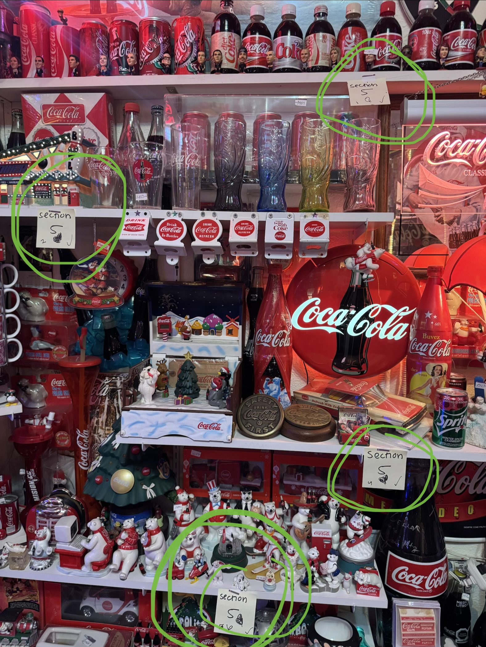 Coca-Cola memorabilia collection growing on display shelves